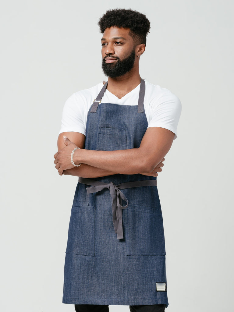 Man posing with his arms crossed modeling Helt's Raw Bar Denim Chef Apron with Pockets.