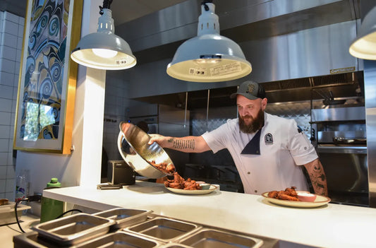 Man wearing a home apron while cooking in the kitchen.
