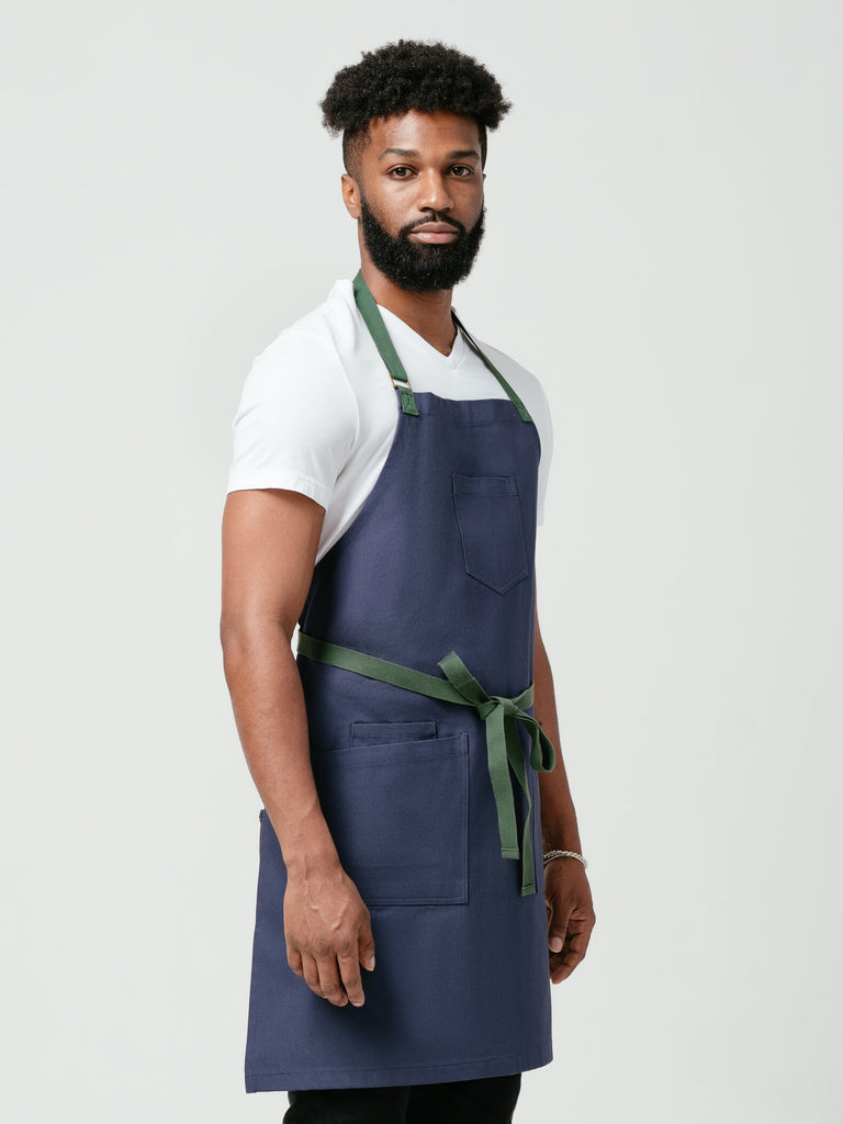 Man posing sideways modeling Helt's Deep-Sea DWR Bib Apron.