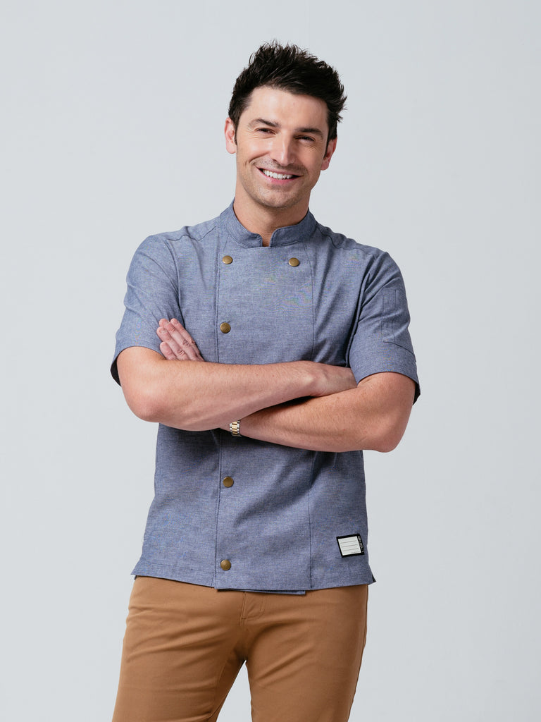 Man posing with his arms crossed modeling Helt Studio's Midtown Chef Coat Denim.