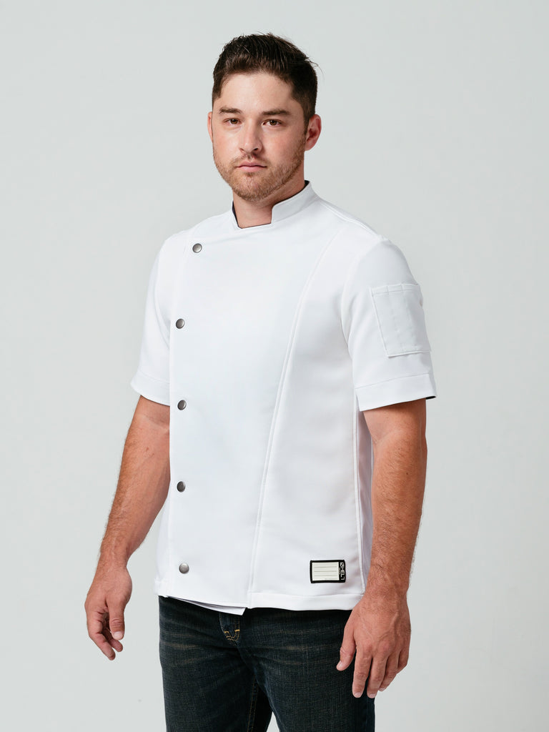 Man posing at an angle modeling Helt Studio's Hipster Chef Coat in white.