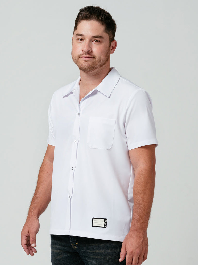 Man posing at an angle modeling Helt's Utility Work Shirt in white.