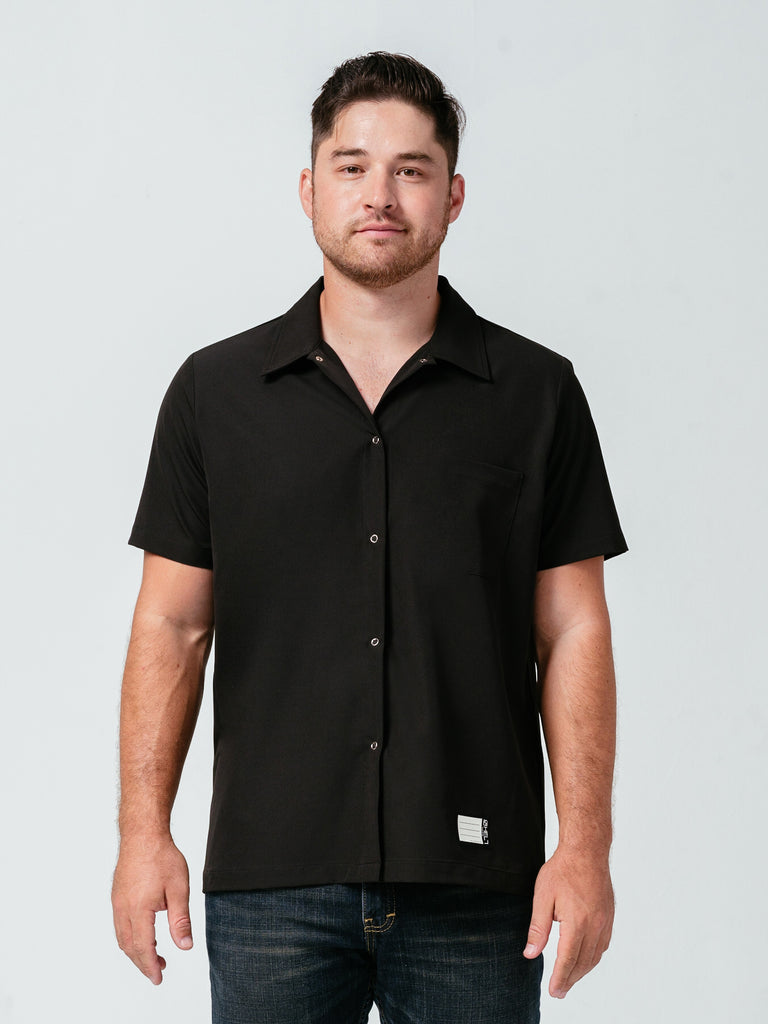 Man modeling Helt Studio's Utility Work Shirt in black.