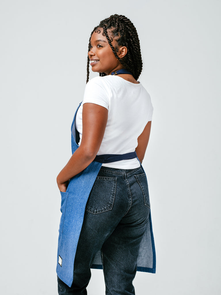 Woman modeling the back of Helt Studio's Ocean Breeze Denim Apron.