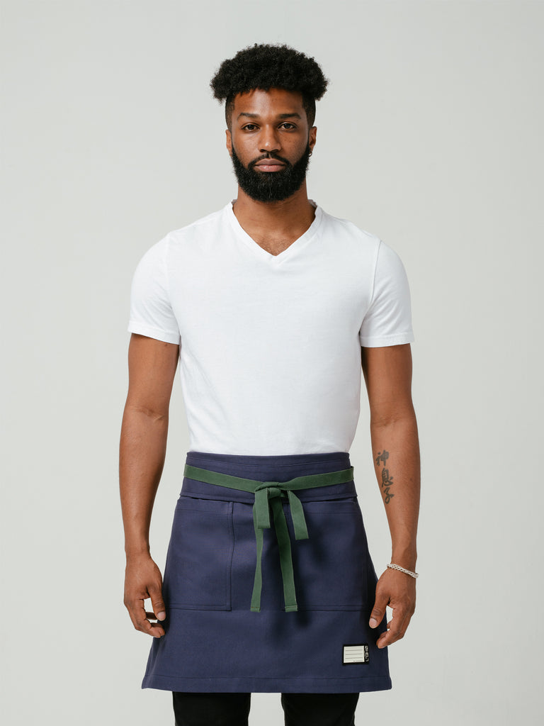 Man modeling Helt Studio's Deep Sea Navy Blue Bistro Apron.